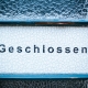 Vintage blue framed wooden door with glass typography "Geschlossen" font – Closed | Markus Spiske, Unsplash licence